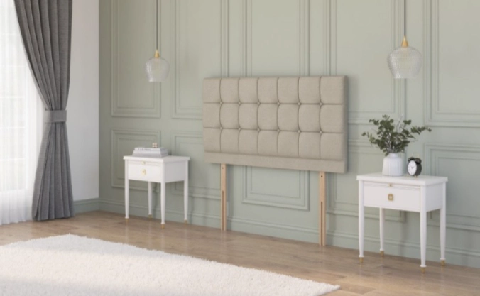  Beige plush velvet strutted headboard with a chesterfield design in a rustic cottage bedroom between two bedside tables.